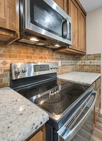 a kitchen with a stove and a microwave