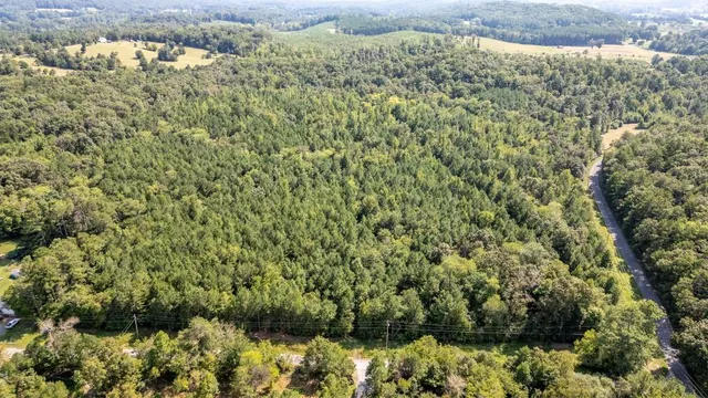 an aerial view of house with yard and mountain view