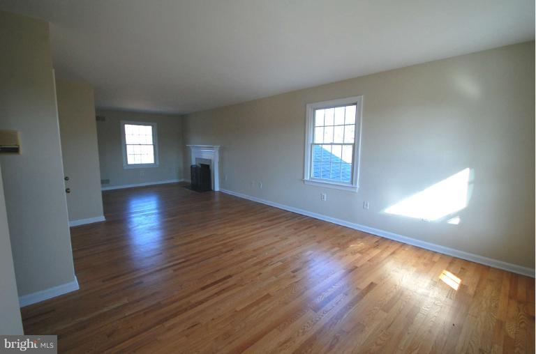 1904 Ednor Road Silver Spring, MD 20905 - Photo 13 of 30 an empty room with wooden floor and windows