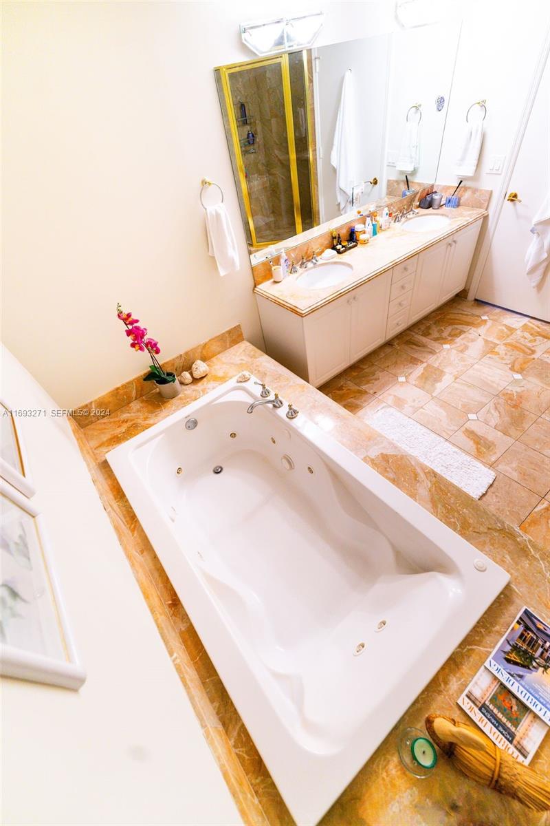 9595 Collins Avenue, Unit N9C Surfside, FL 33154 - Photo 19 of 31 a bathroom with a tub sink and mirror