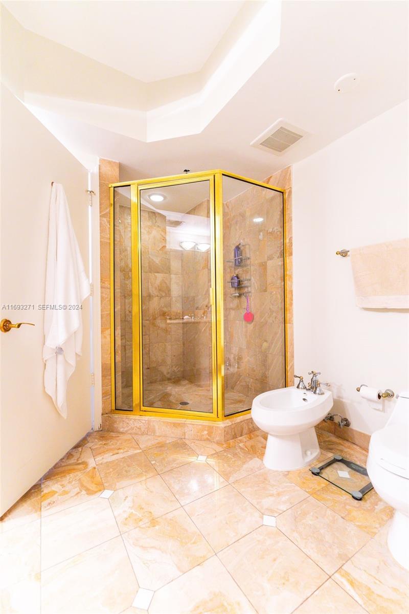 9595 Collins Avenue, Unit N9C Surfside, FL 33154 - Photo 20 of 31 a bathroom with a toilet tub and shower