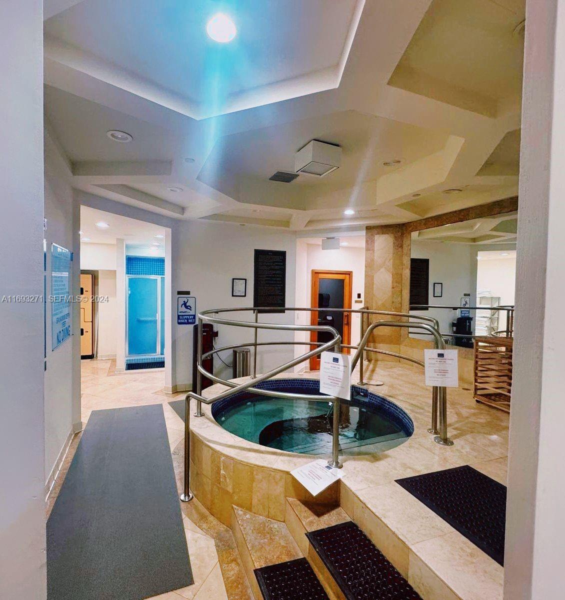 9595 Collins Avenue, Unit N9C Surfside, FL 33154 - Photo 29 of 31 a kitchen with stainless steel appliances kitchen island granite countertop a sink and refrigerator