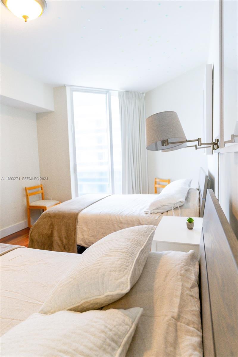 9595 Collins Avenue, Unit N9C Surfside, FL 33154 - Photo 5 of 31 a bedroom with a bed and a painting