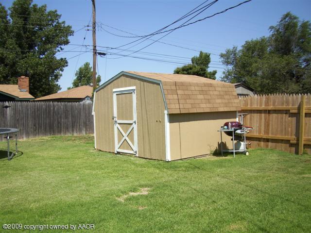 5108 South Bonham Street Amarillo, TX 79110 - Photo 13 of 13 a view of a backyard with a small cabin and a chair