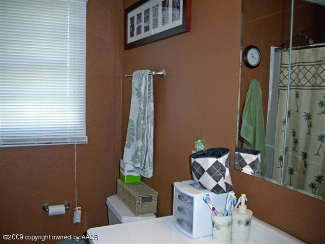 5108 South Bonham Street Amarillo, TX 79110 - Photo 6 of 13 a bathroom with a toilet and a sink
