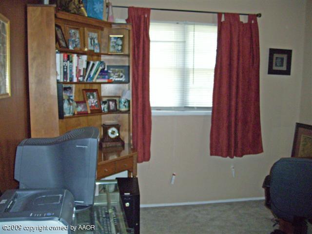5108 South Bonham Street Amarillo, TX 79110 - Photo 8 of 13 a room with furniture and a book shelf