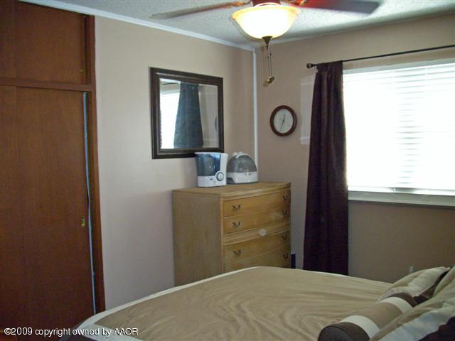 5108 South Bonham Street Amarillo, TX 79110 - Photo 9 of 13 a bedroom with a bed and a window