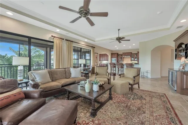 a living room with furniture ceiling fan and a rug