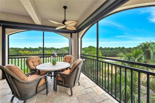 a view of a porch with furniture and a backyard