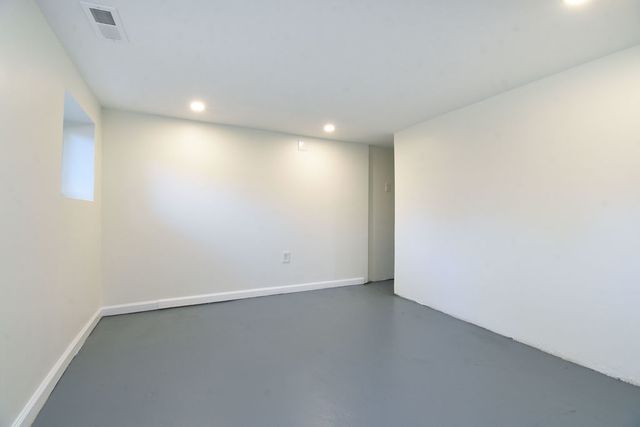 an empty room with a empty space and window