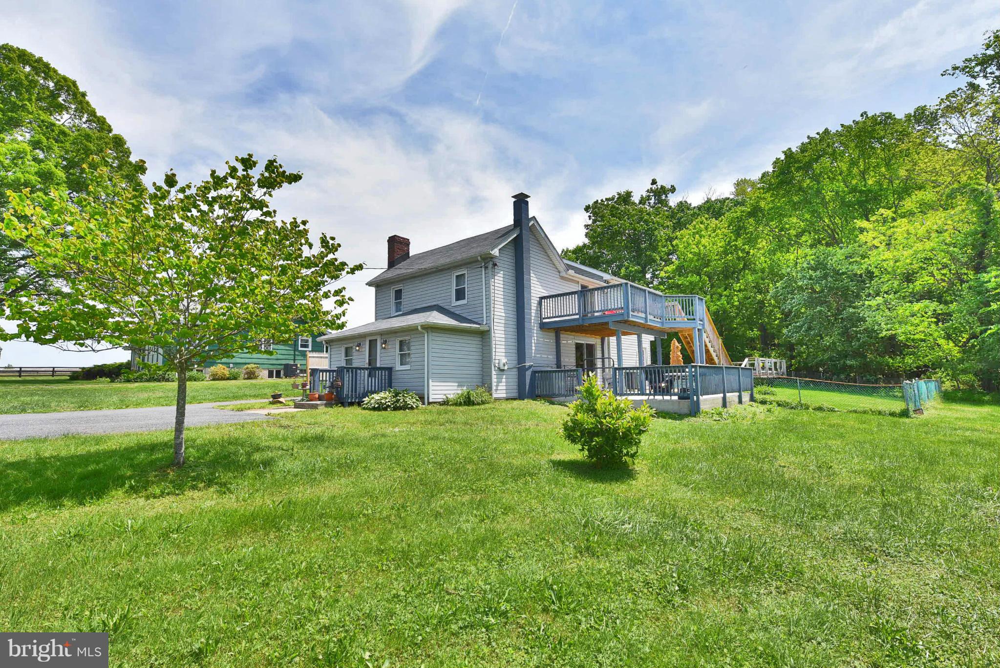 417 Reckord Road Fallston, MD 21047 - Photo 1 of 30 a house that is sitting in the grass with large trees and plants