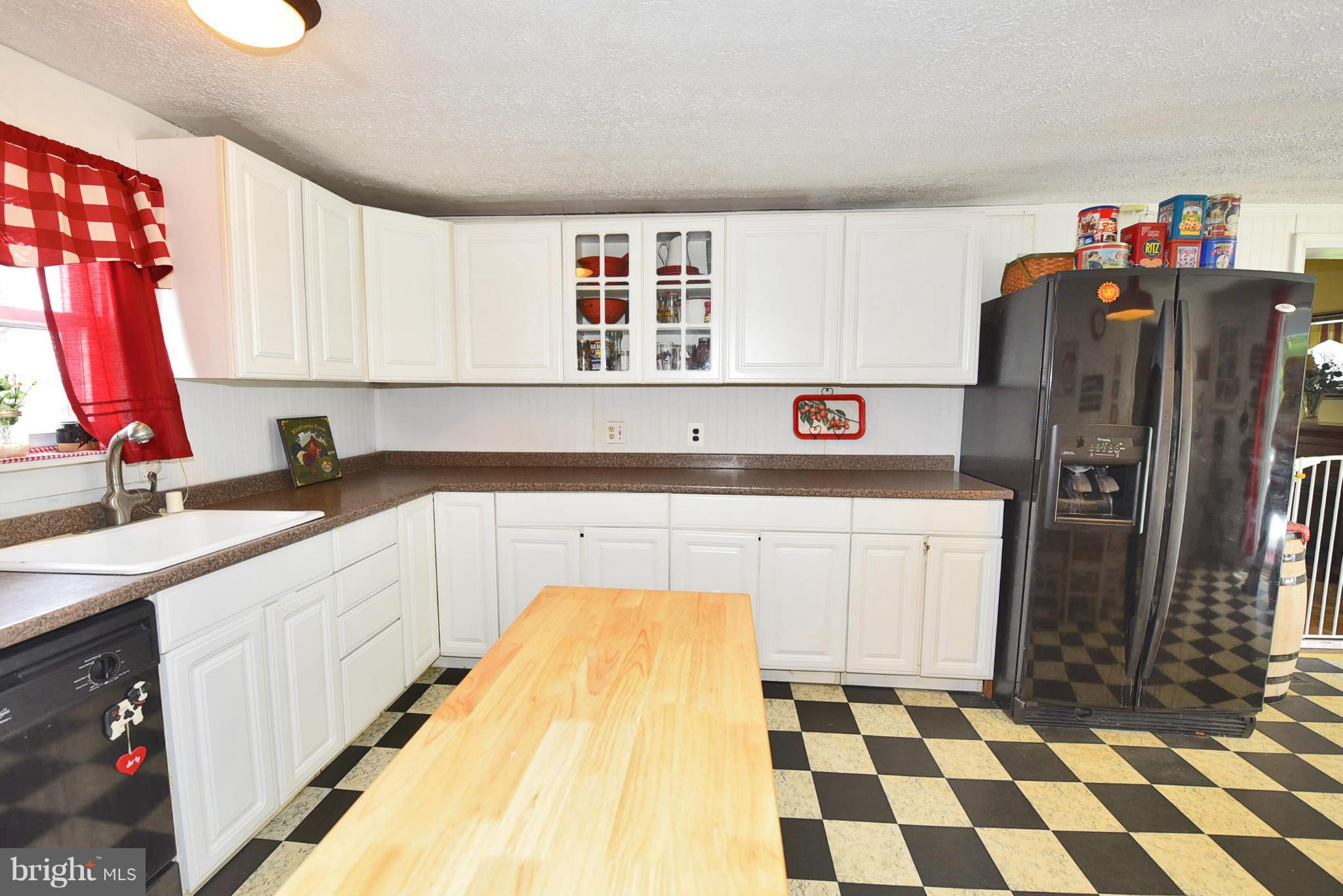 417 Reckord Road Fallston, MD 21047 - Photo 8 of 30 a kitchen with a sink a refrigerator and cabinets