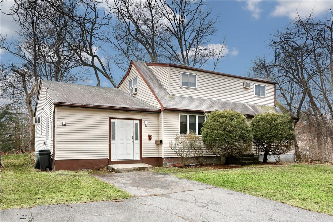 a front view of a house with a garden and plants