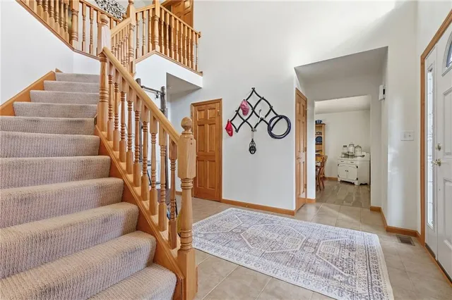 a view of an entryway with wooden floor and a front door