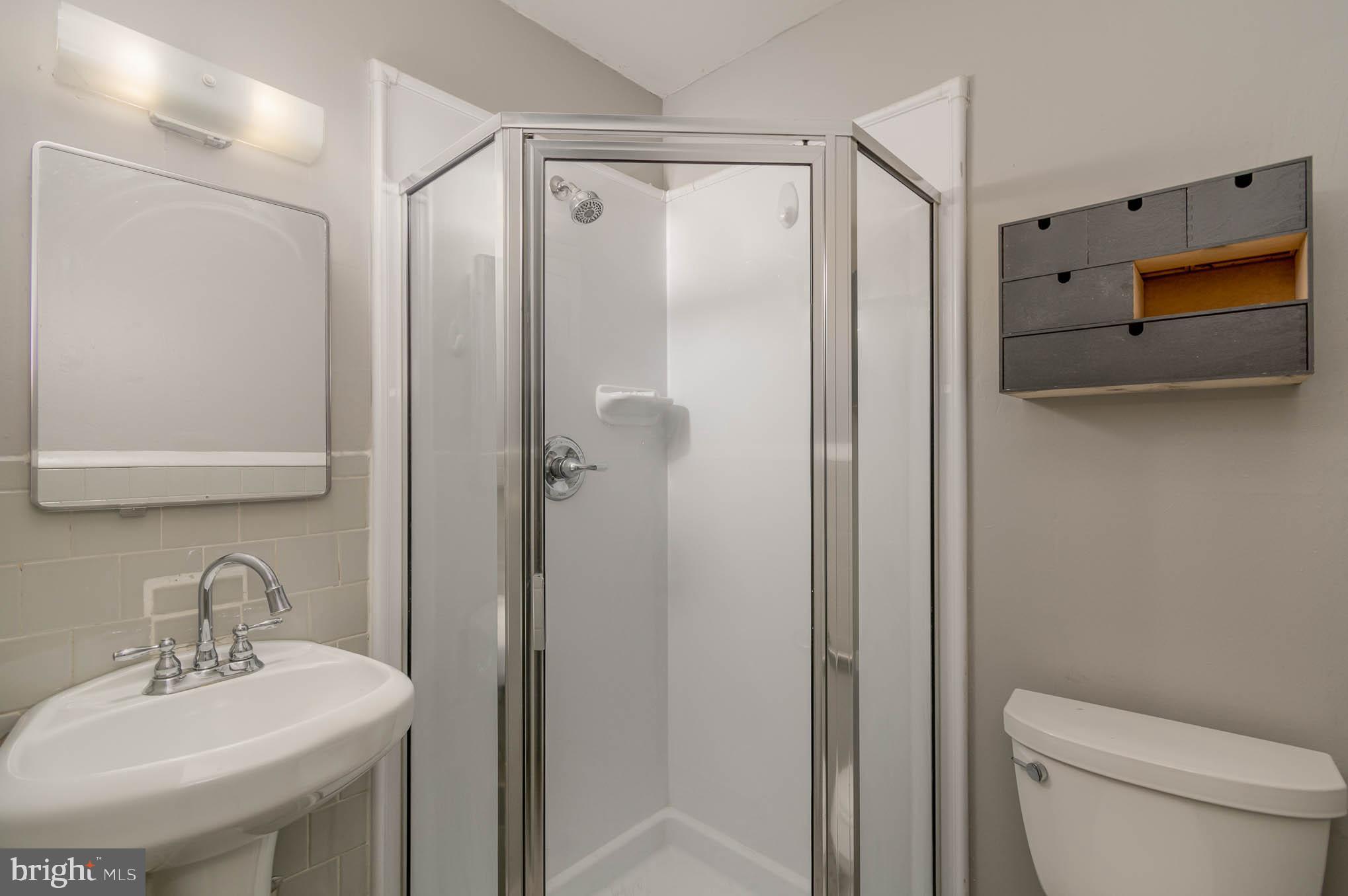 4612 Tema Road Pikesville, MD 21208 - Photo 20 of 27 a bathroom with a shower a toilet and sink