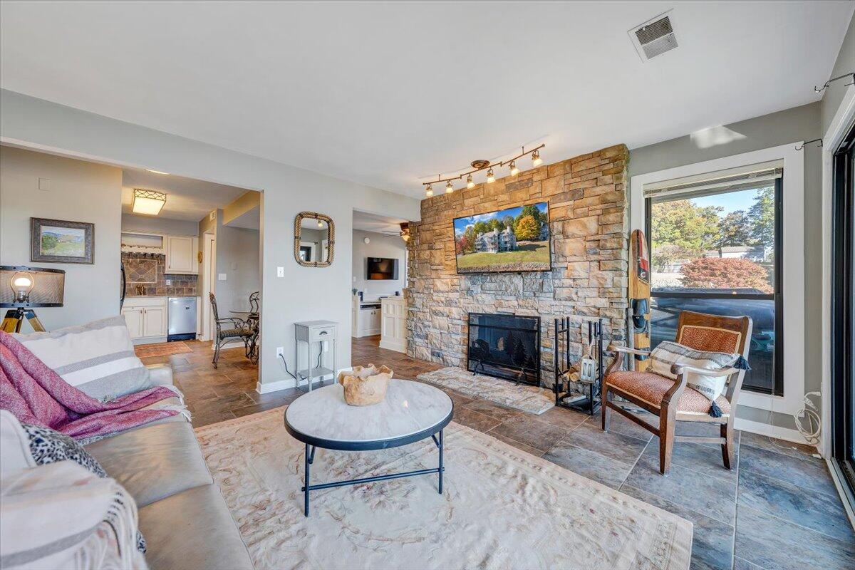 100 Dockside Circle, Unit 201 Moneta, VA 24121 - Photo 12 of 52 a living room with furniture a fireplace and a table