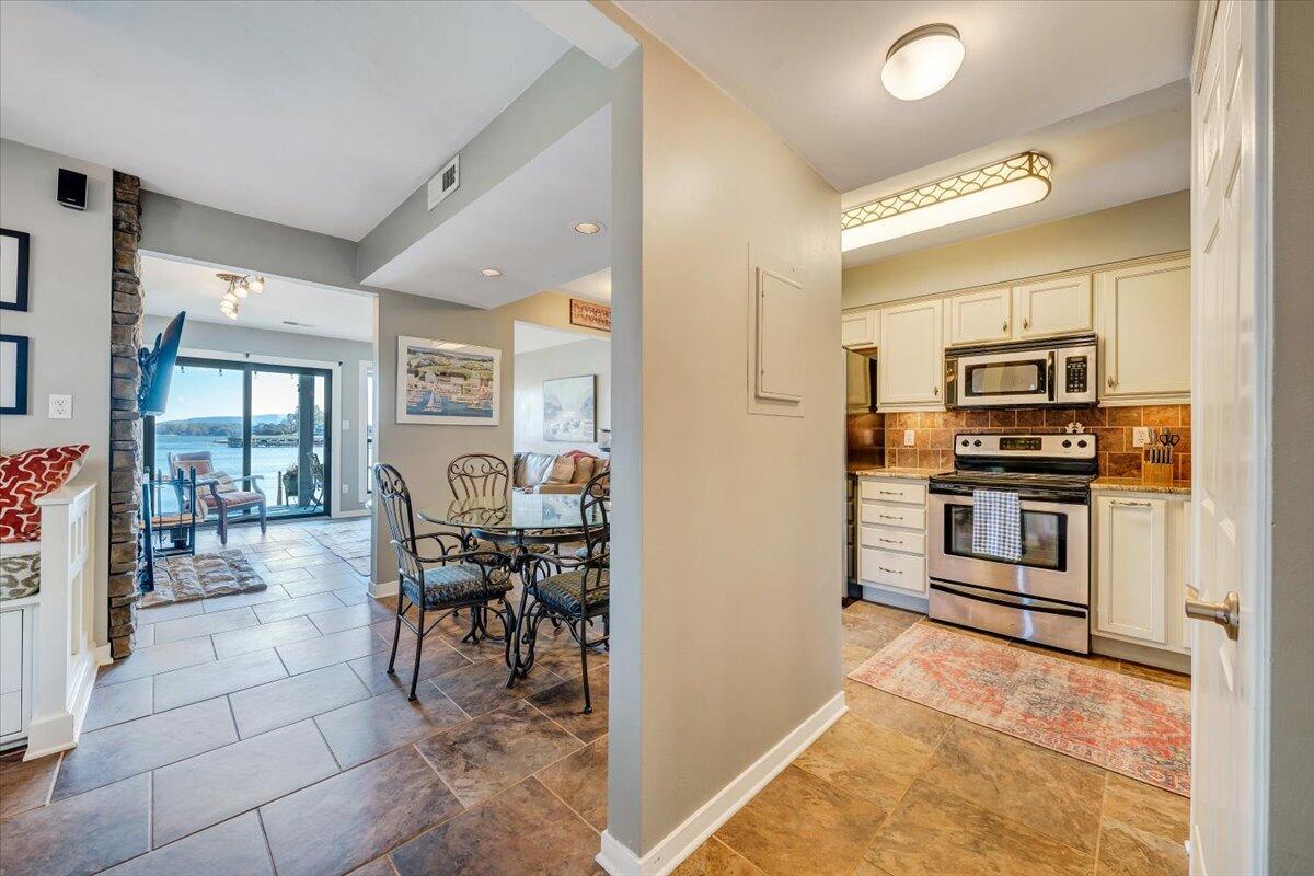 100 Dockside Circle, Unit 201 Moneta, VA 24121 - Photo 16 of 52 a kitchen with stainless steel appliances kitchen island granite countertop a stove and cabinets