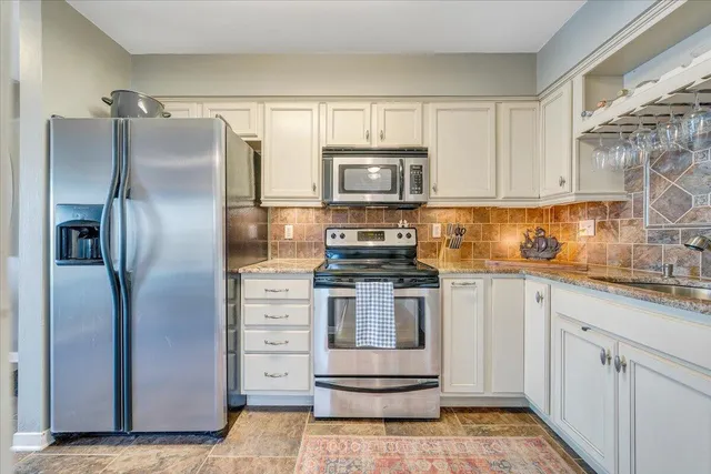 a view of a patio with table and chairs and wooden floor