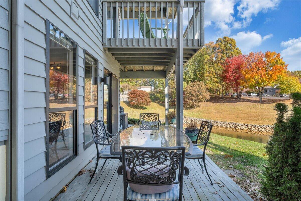 100 Dockside Circle, Unit 201 Moneta, VA 24121 - Photo 43 of 52 a view of a patio with table and chairs and wooden floor