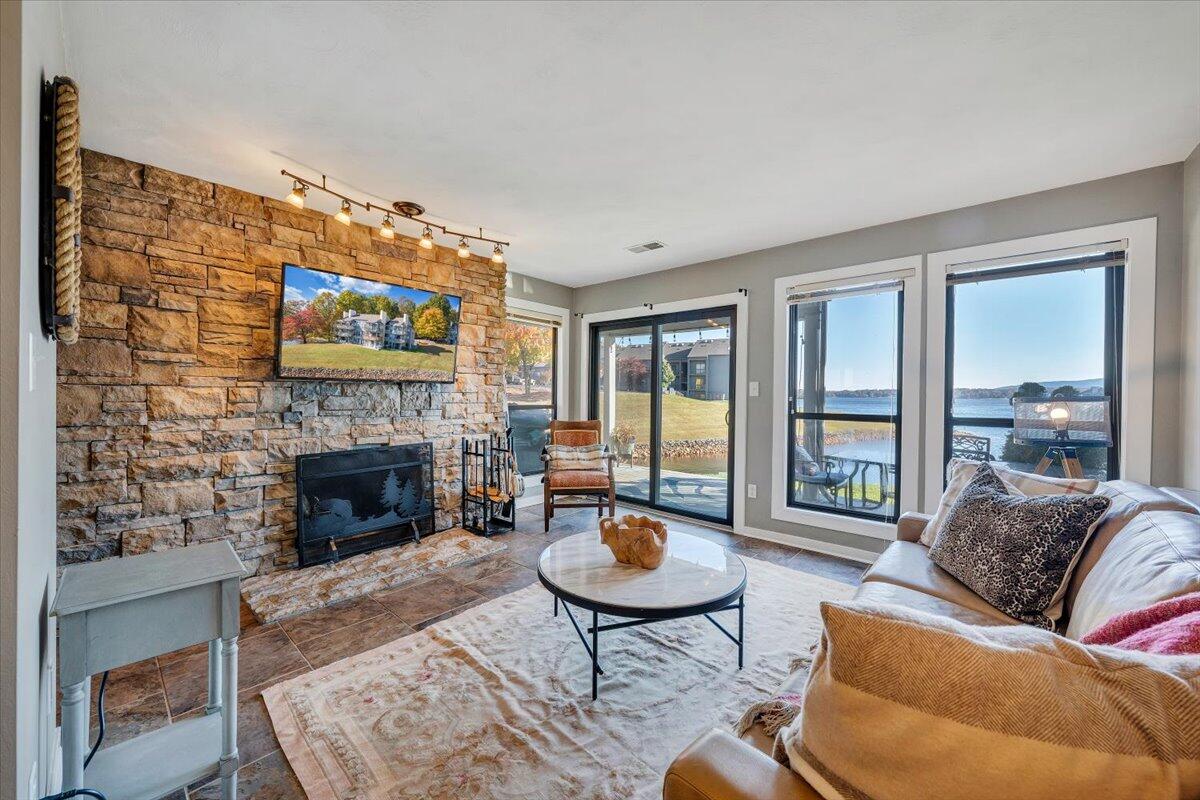 100 Dockside Circle, Unit 201 Moneta, VA 24121 - Photo 7 of 52 a living room with furniture a flat screen tv and a fireplace