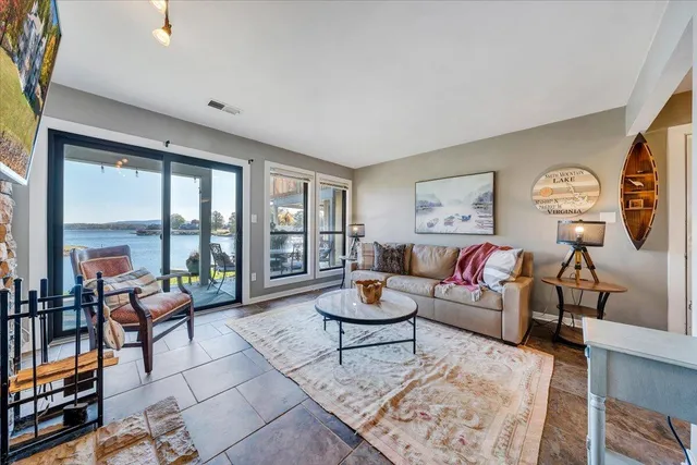 a kitchen with stainless steel appliances kitchen island granite countertop a stove and cabinets