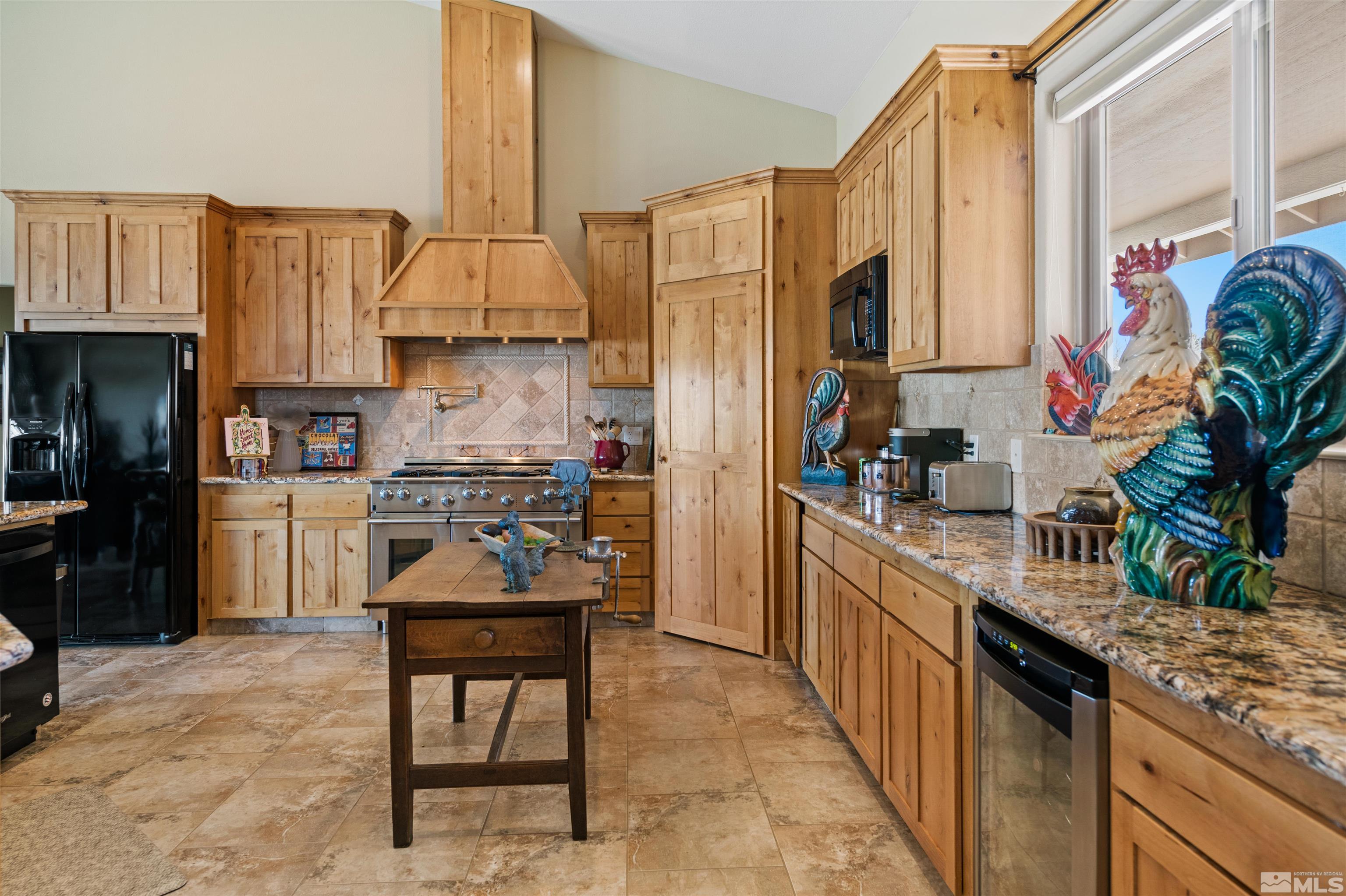 2428 Hasbita Lane Minden, NV 89423 - Photo 13 of 33 a kitchen with stainless steel appliances kitchen island granite countertop a refrigerator a stove and a wooden cabinets