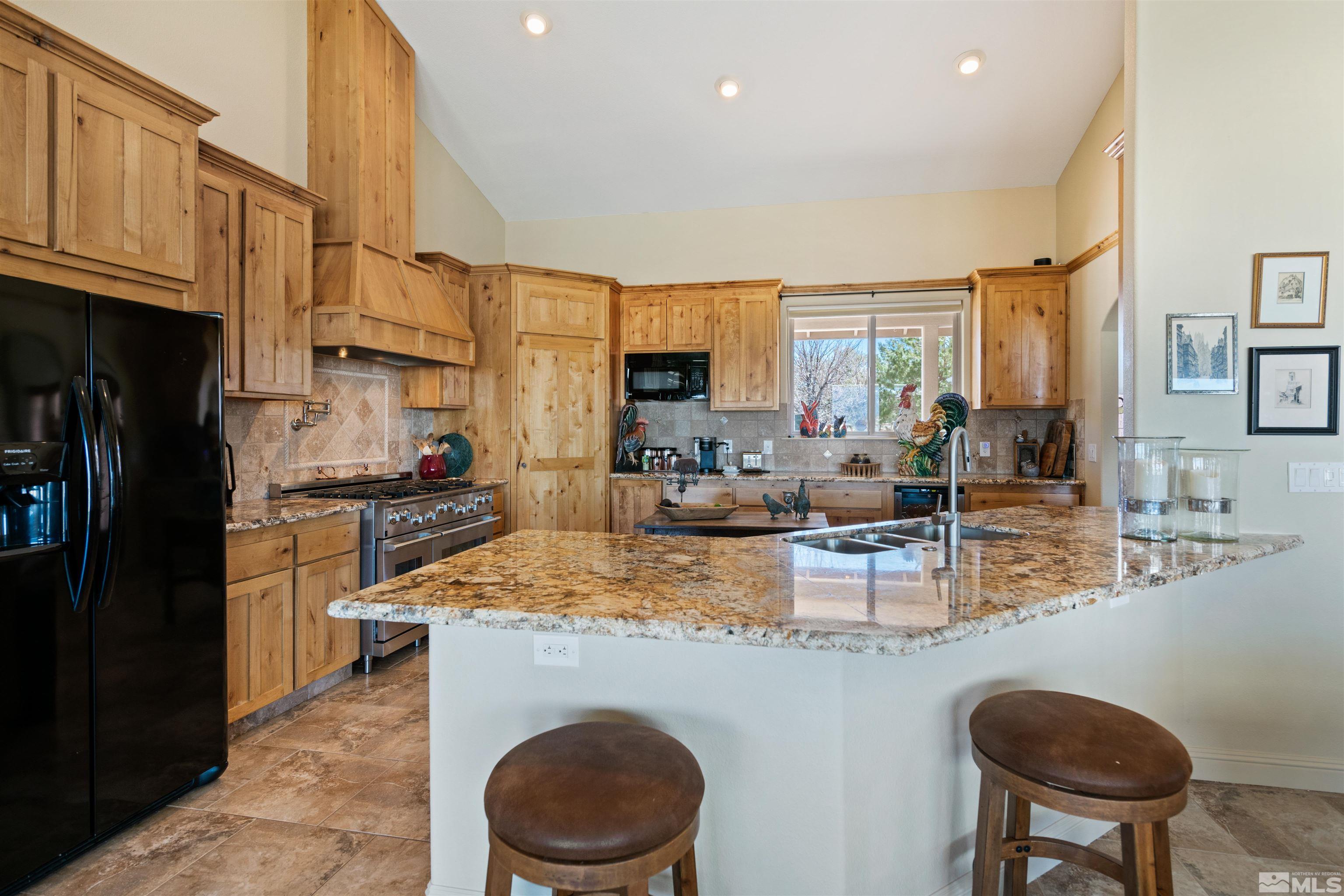 2428 Hasbita Lane Minden, NV 89423 - Photo 15 of 33 a kitchen with sink a stove and chairs