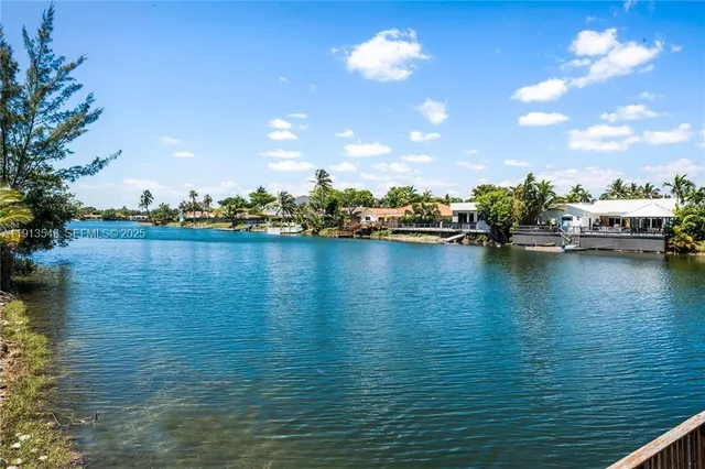 a bedroom with a large bed and a flat tv screen