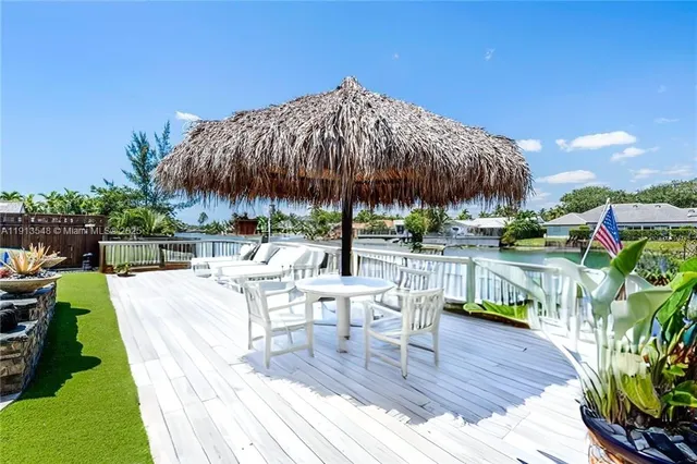 a view of a house with pool and chairs