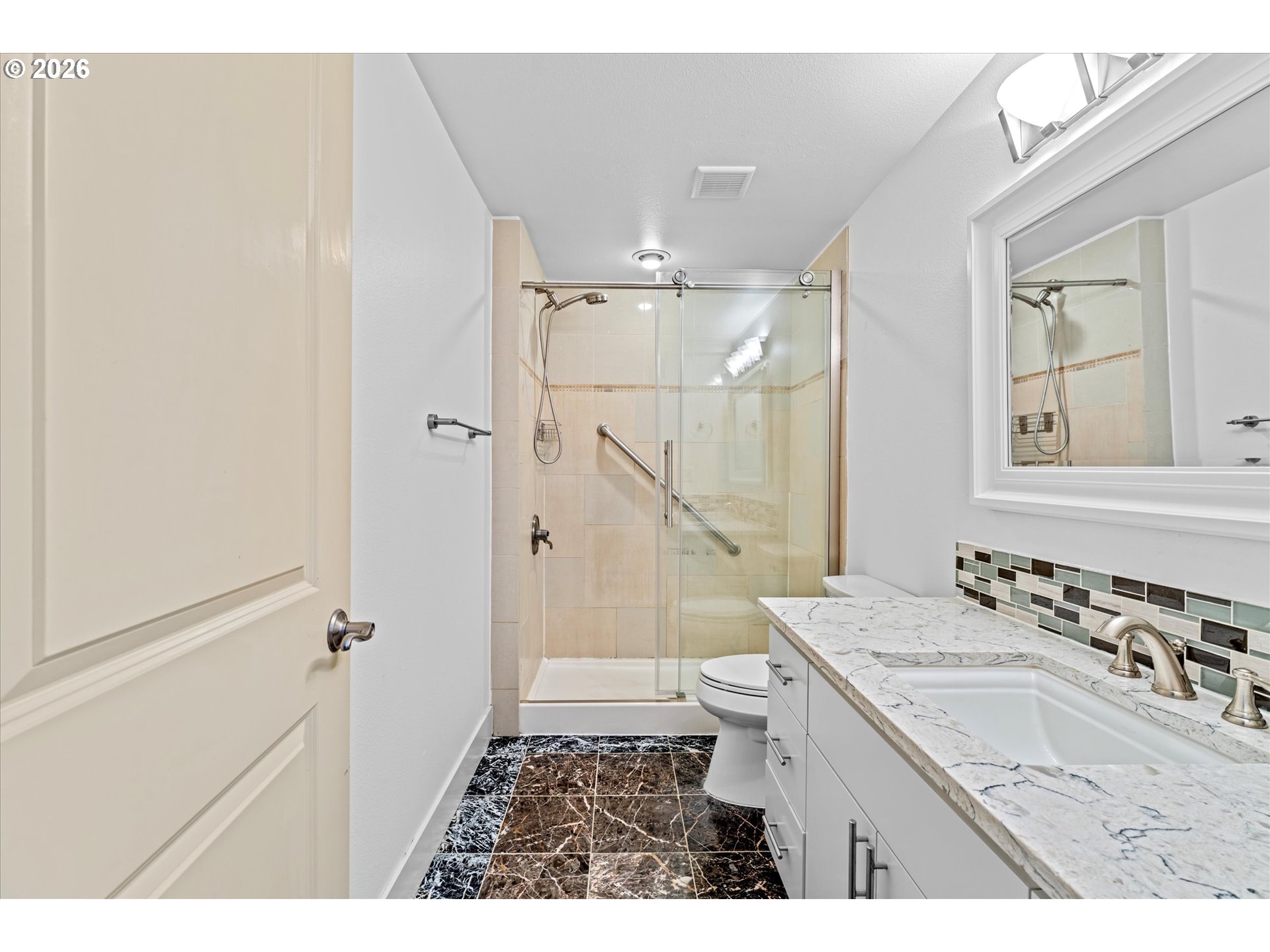 1727 Northwest Ogden Street Camas, WA 98607 - Photo 40 of 48 a bathroom with a sink a toilet a mirror and shower