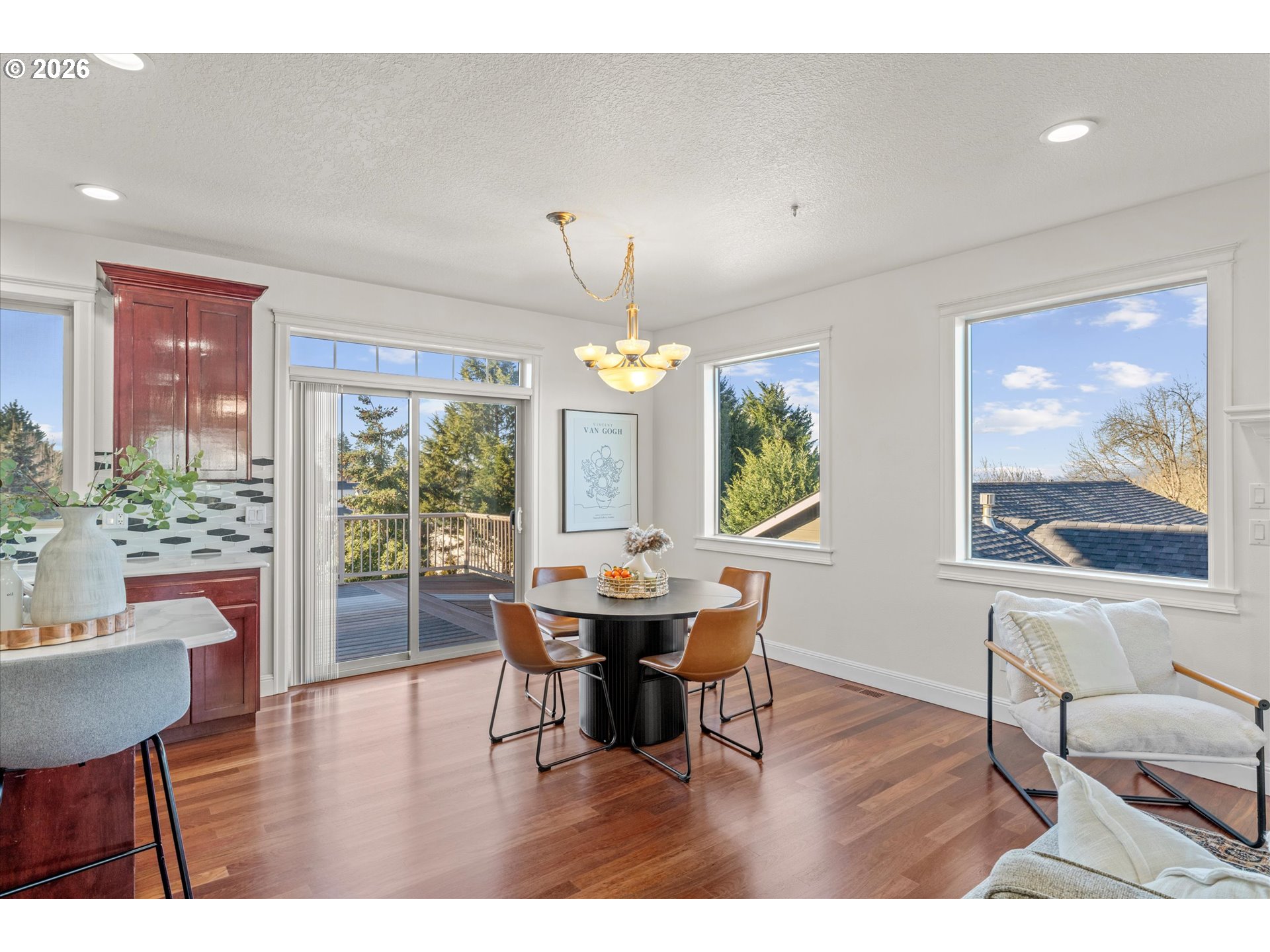 1727 Northwest Ogden Street Camas, WA 98607 - Photo 10 of 48 a dining room with wooden floor a chandelier a wooden table and chairs