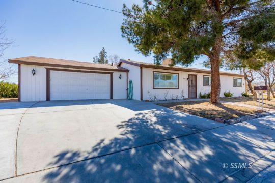 901 West Rader Avenue Ridgecrest, CA 93555 - Photo 4 of 26 a front view of a house with a yard and garage