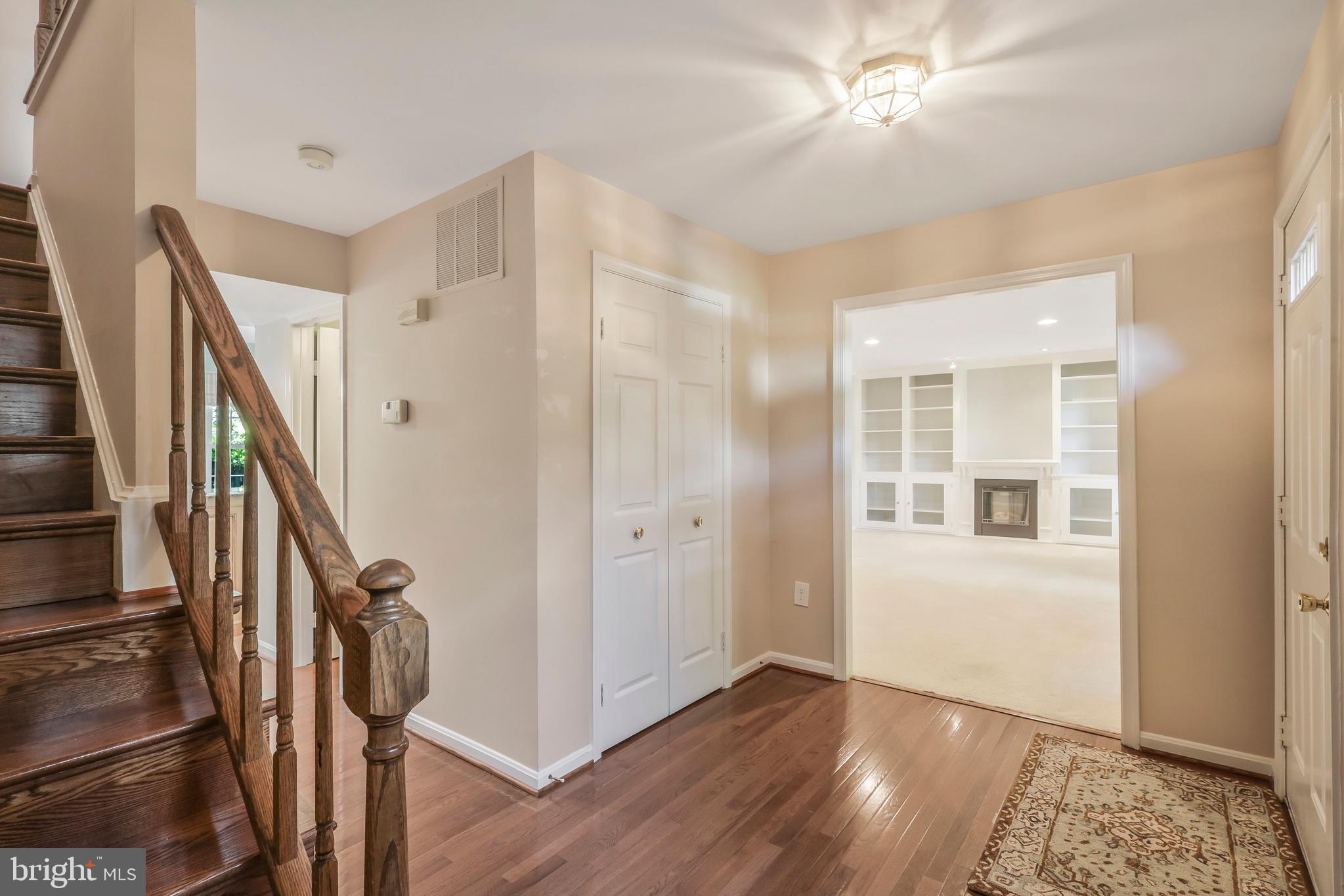 8711 Shadowlake Way Springfield, VA 22153 - Photo 4 of 49 Hardwood floors and staircase in foyer