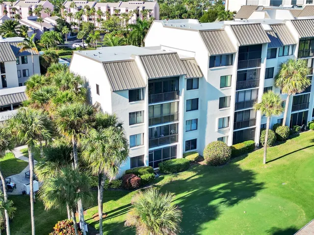a dining room with furniture a chandelier and wooden floor