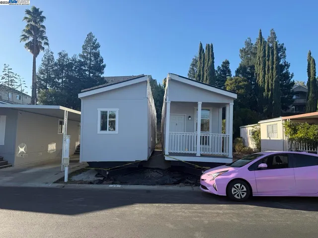 a front view of a house with parking space