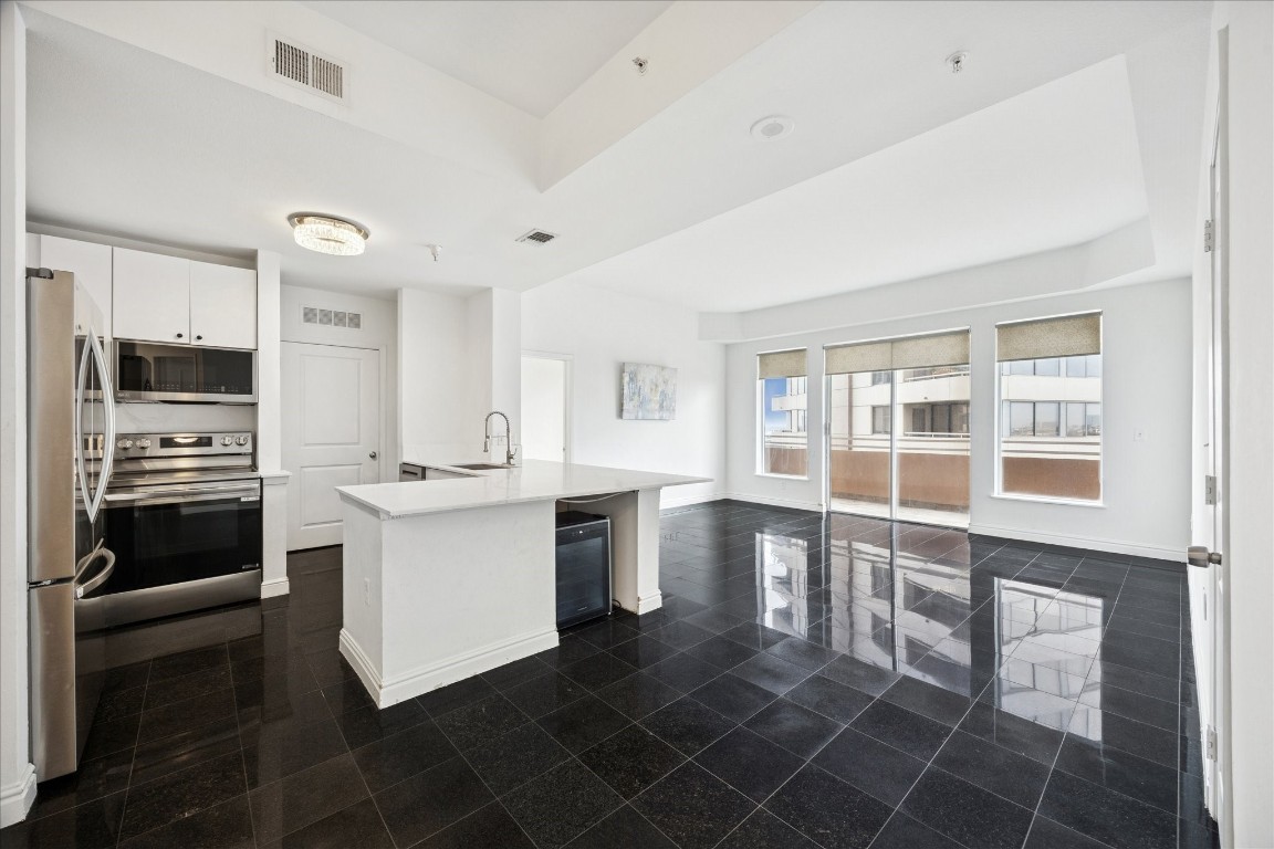 a kitchen with a stove a sink and a refrigerator
