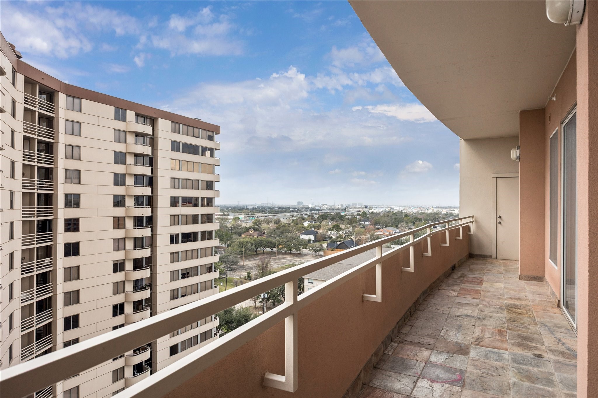 3505 Sage Road, Unit 1106 Houston, TX 77056 - Photo 15 of 22 An expansive private balcony serves as a true extension of the living space, offering three separate access points that create effortless indoor-outdoor flow.