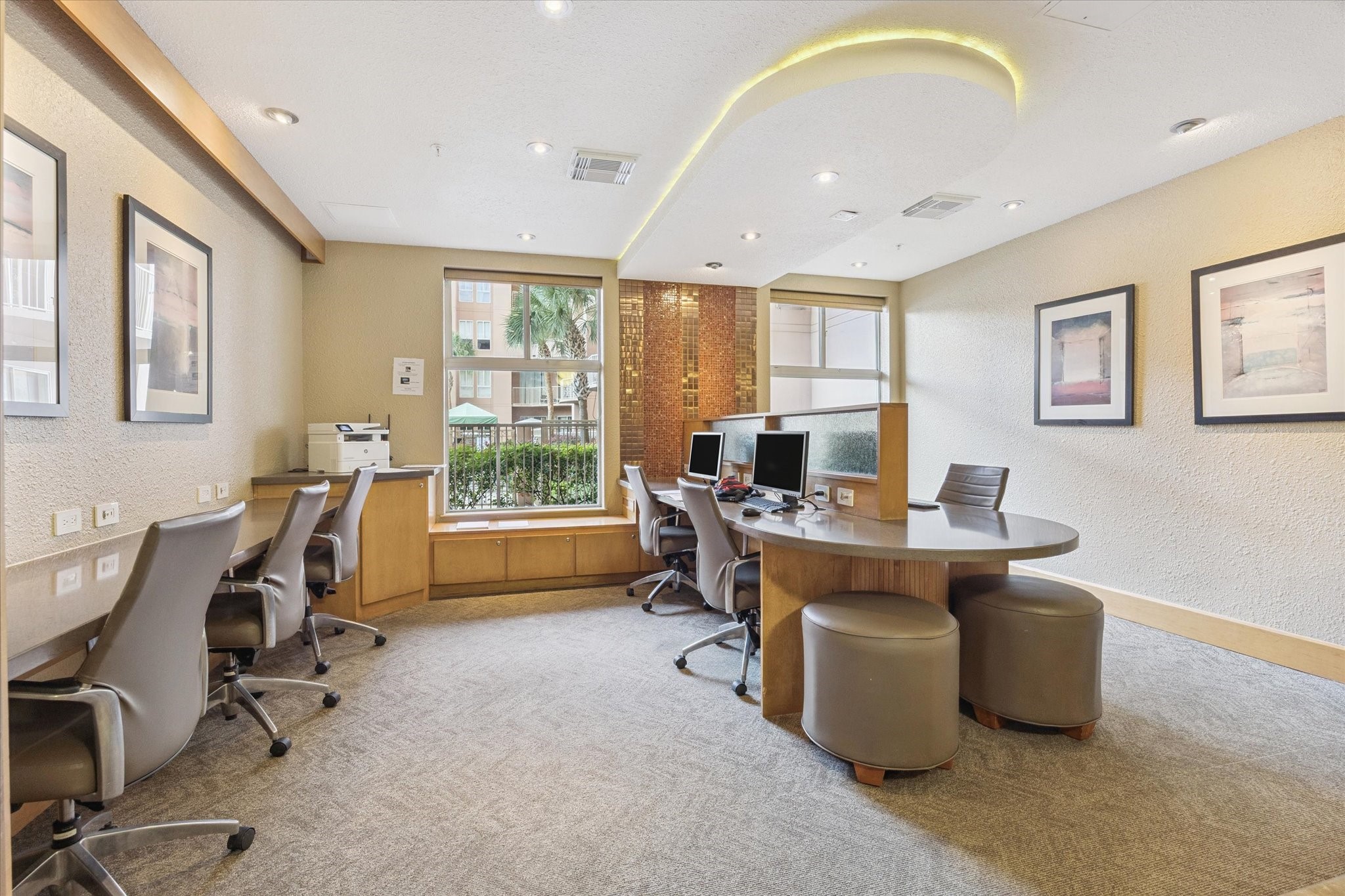 3505 Sage Road, Unit 1106 Houston, TX 77056 - Photo 21 of 22 The first-floor business center provides a convenient and professionally designed workspace for residents. Equipped with a computer, printer, and high-speed Wi-Fi access, this thoughtfully arranged office setting makes it easy to work remotely, print documents, or handle daily tasks without leaving the building.