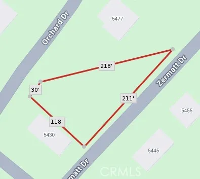 an aerial view of a house with a mountain