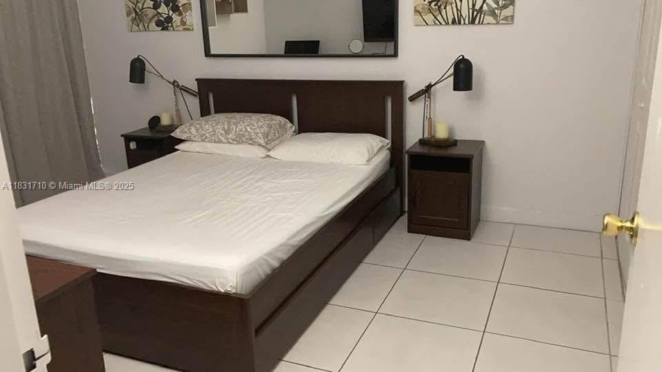 2160 Southwest 16th Avenue, Unit 421 Miami, FL 33145 - Photo 13 of 19 a bedroom with a bed and a table