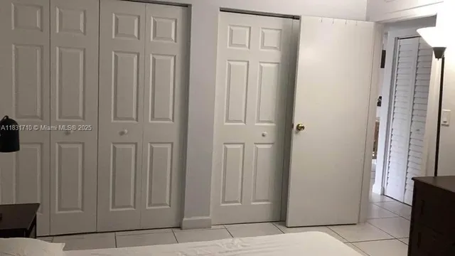 a room with a bed and a dresser