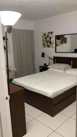 a bathroom with a granite countertop sink a toilet and a mirror