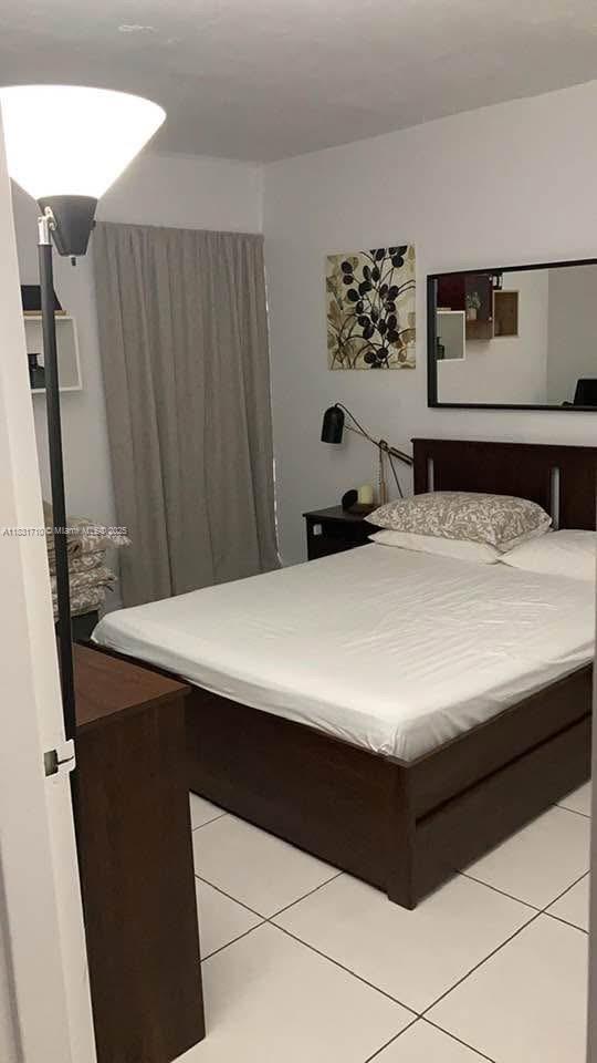 2160 Southwest 16th Avenue, Unit 421 Miami, FL 33145 - Photo 15 of 19 a room with a bed and a dresser