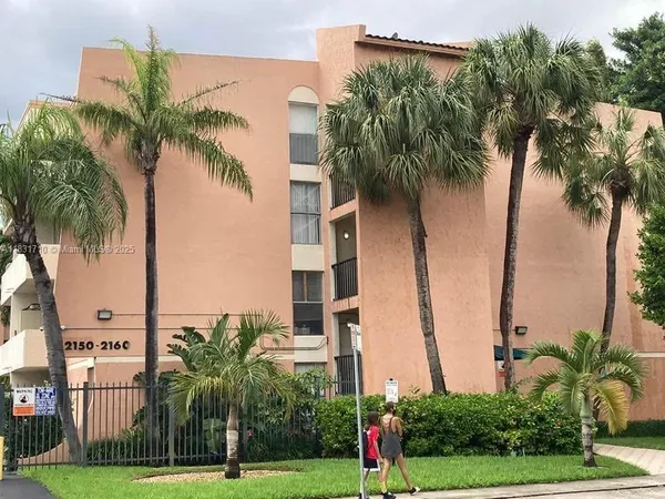 a view of a palm trees in front of a building