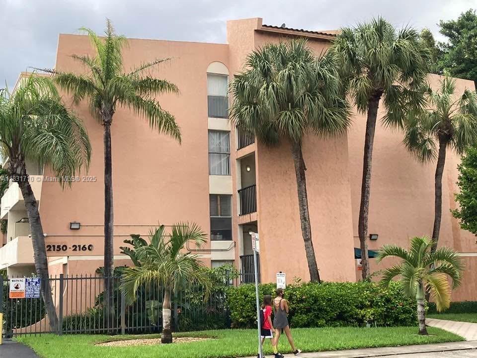 2160 Southwest 16th Avenue, Unit 421 Miami, FL 33145 - Photo 2 of 19 a view of a palm trees in front of a building
