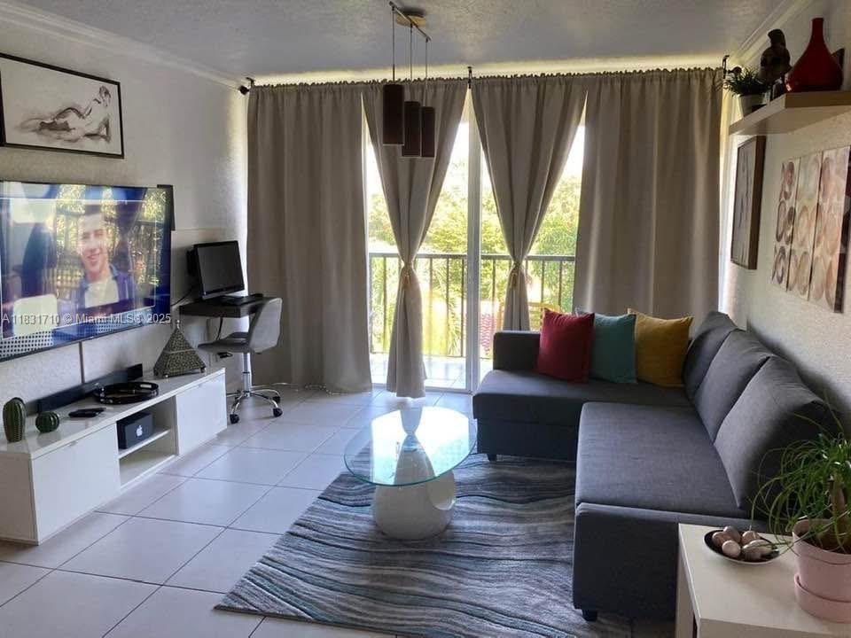 2160 Southwest 16th Avenue, Unit 421 Miami, FL 33145 - Photo 4 of 19 a living room with furniture a flat screen tv and a window