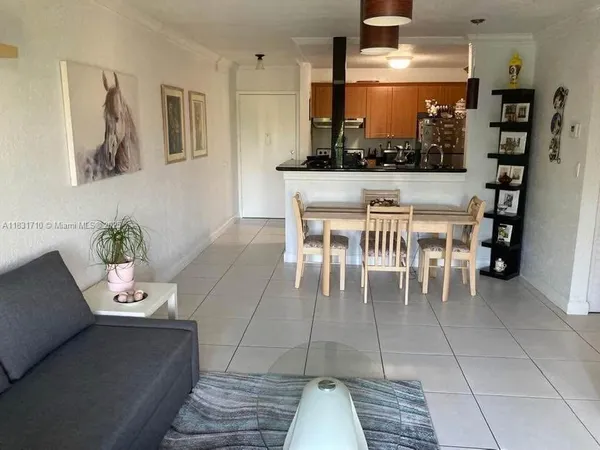 a dining room with furniture and a floor to ceiling window