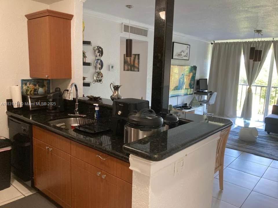 2160 Southwest 16th Avenue, Unit 421 Miami, FL 33145 - Photo 7 of 19 a kitchen with granite countertop a sink and cabinets