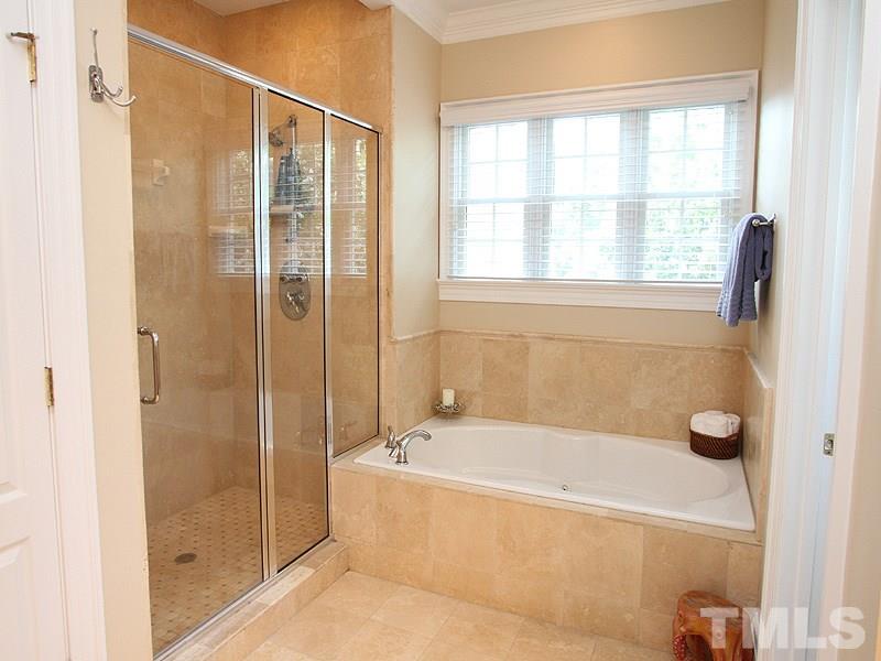 3710 Congeniality Way Raleigh, NC 27613 - Photo 11 of 23 Elegance describes this Master Bath with tile floors and oversized dual shower, separate whirlpool tub, dual granite vanity, and two walk-in closets.