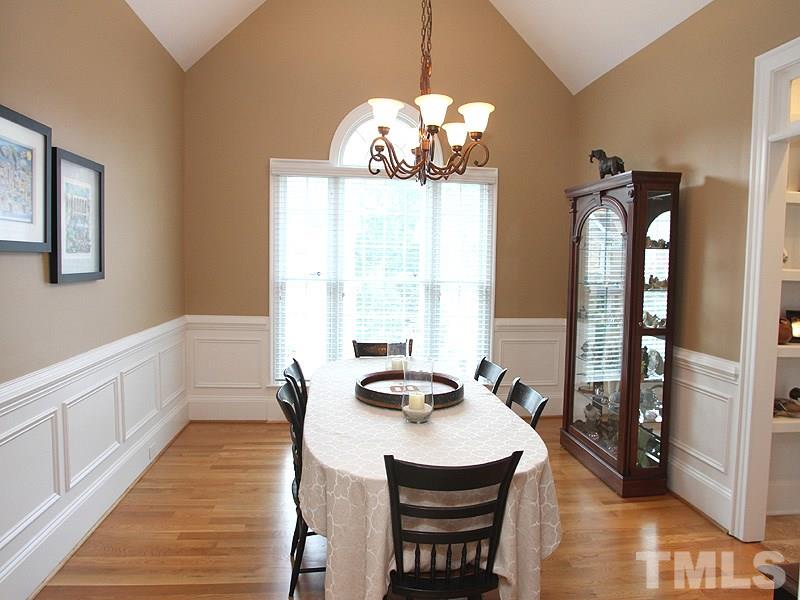 3710 Congeniality Way Raleigh, NC 27613 - Photo 4 of 23 Hardwoods, cathedral ceiling, wainscoting, and transom windows over doorways are some of the features.